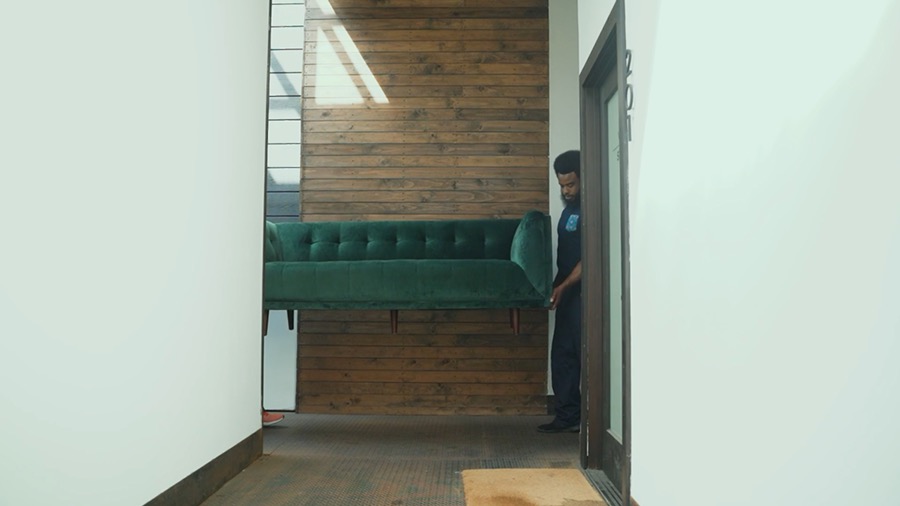 An ML Movers crew member carrying furniture through a home